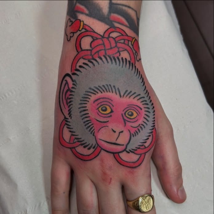 Vibrant Monkey Tattoo on Hand With Bold Colors