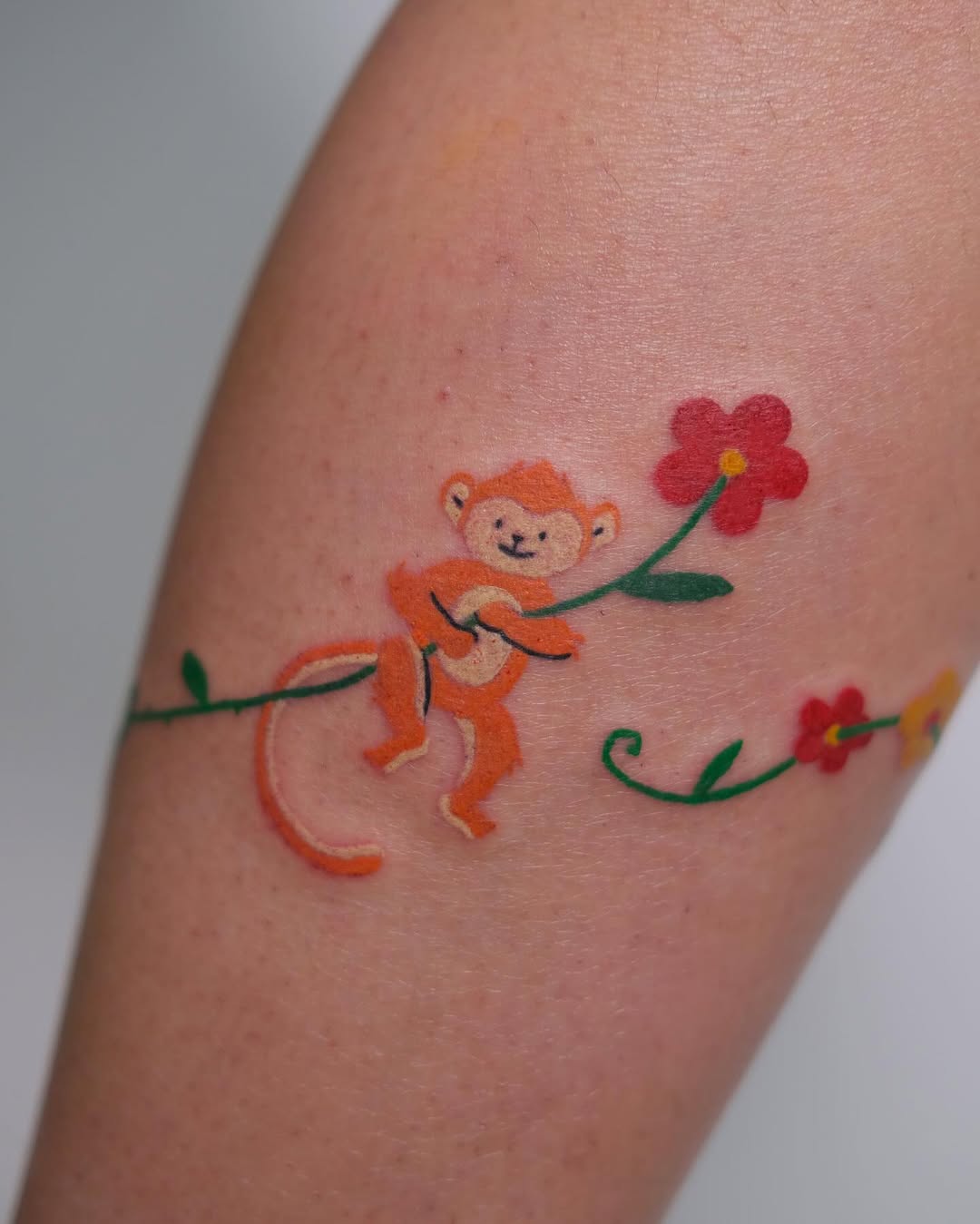 Charming monkey tattoo with floral elements