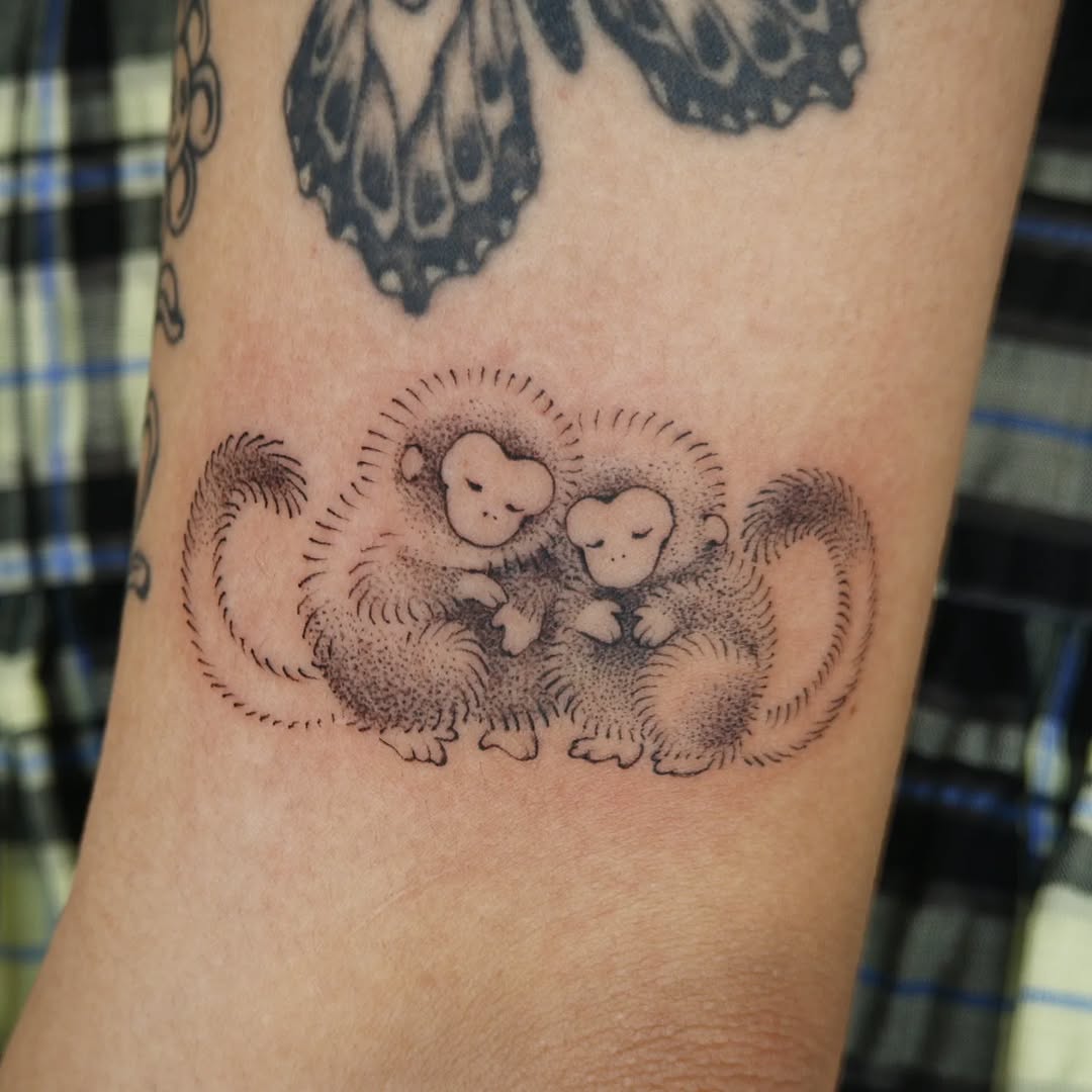 Charming duo of cuddly monkey tattoos