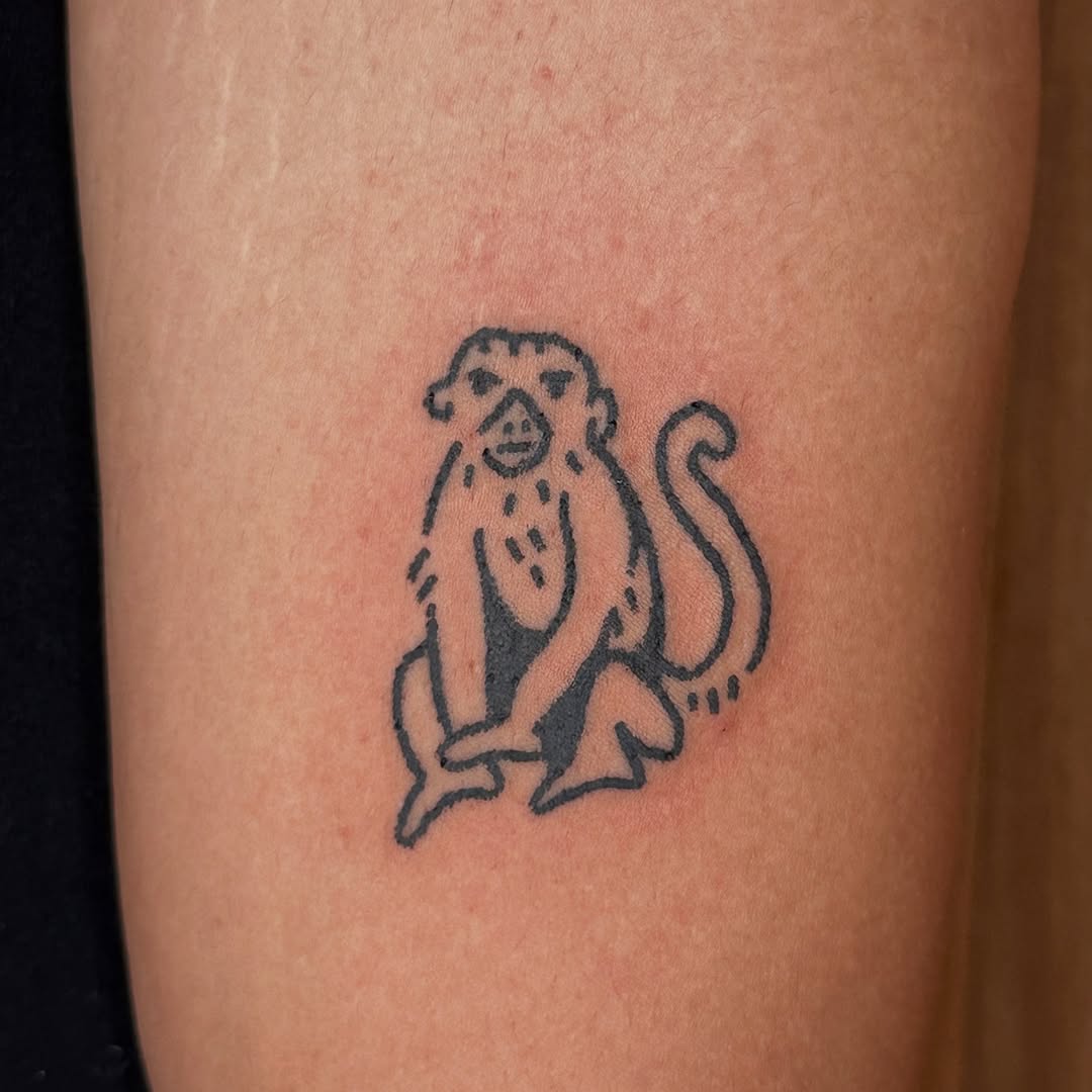 Stylish minimalist monkey tattoo in black ink
