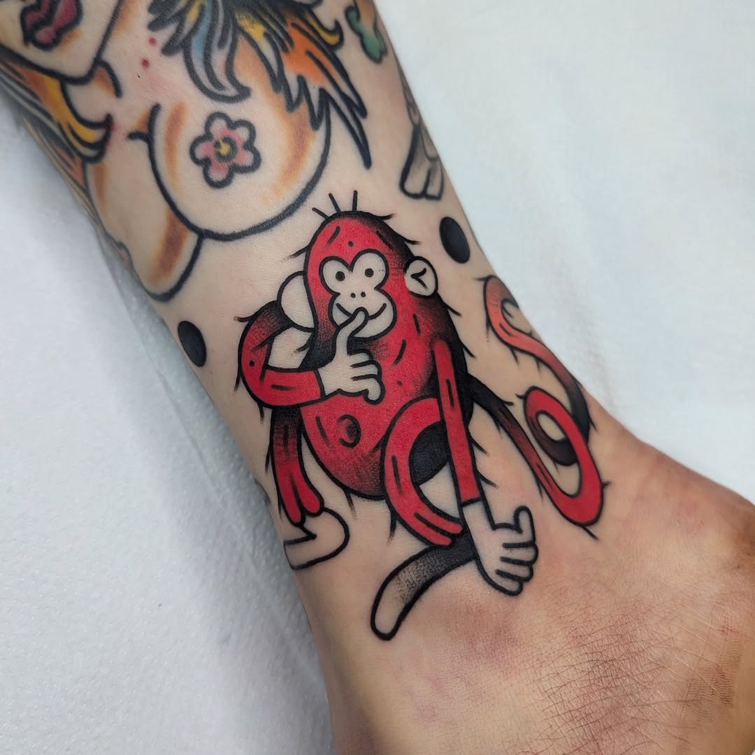 Vibrant monkey tattoo with playful expression