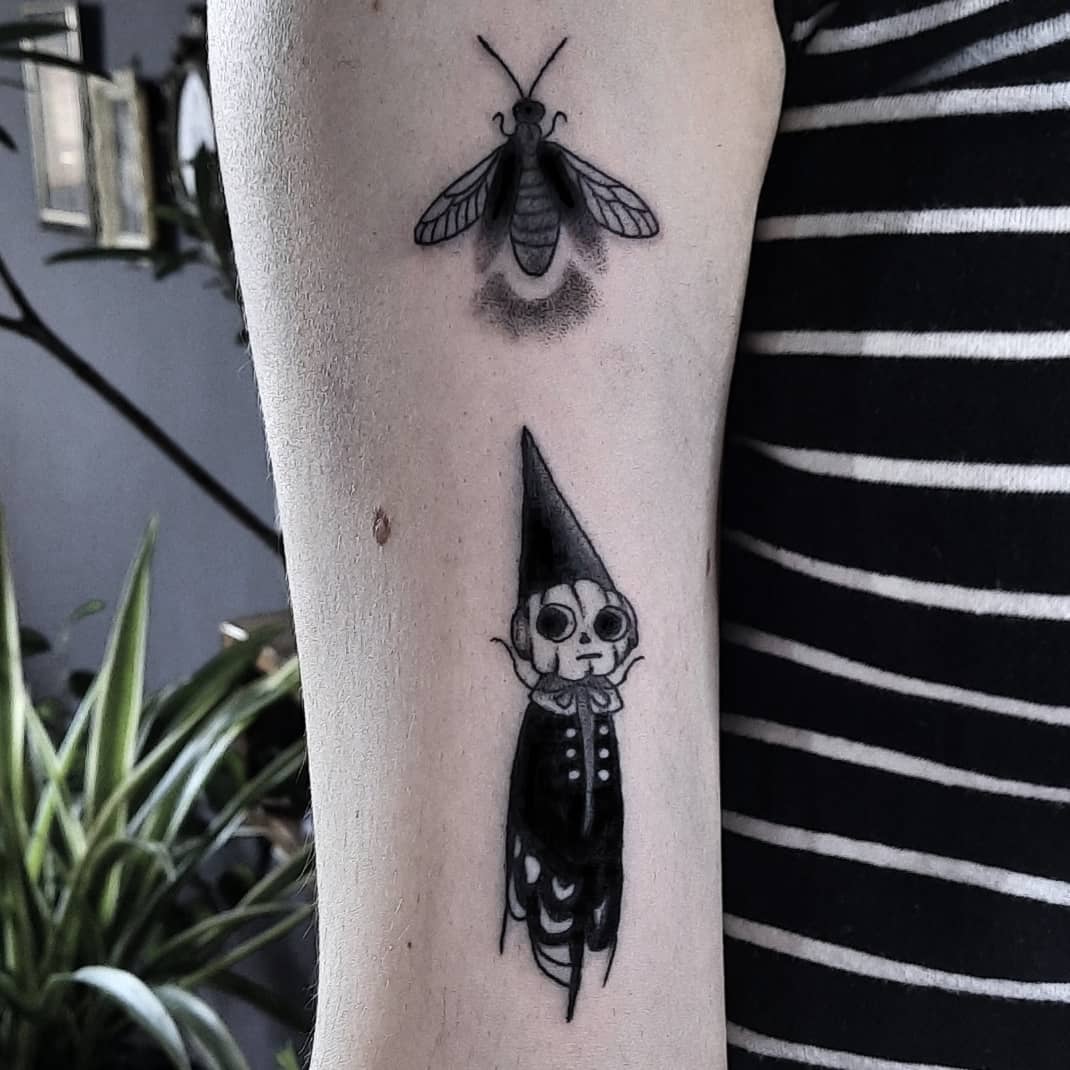 Elegant blackwork firefly tattoo design
