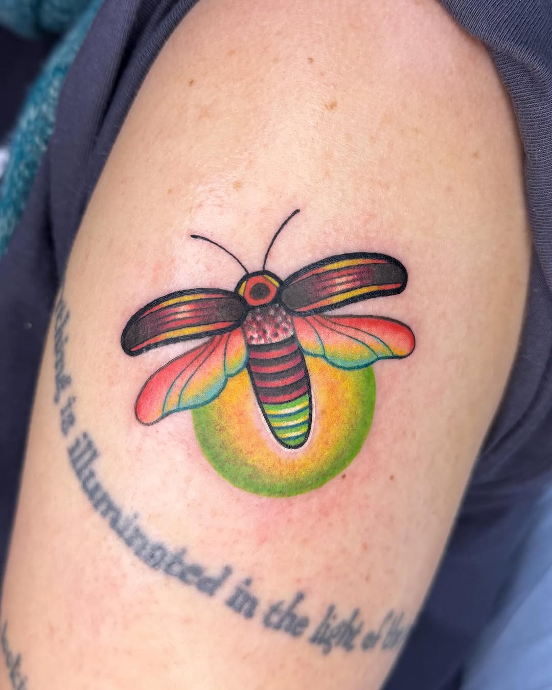 Luminous firefly tattoo with vibrant colors
