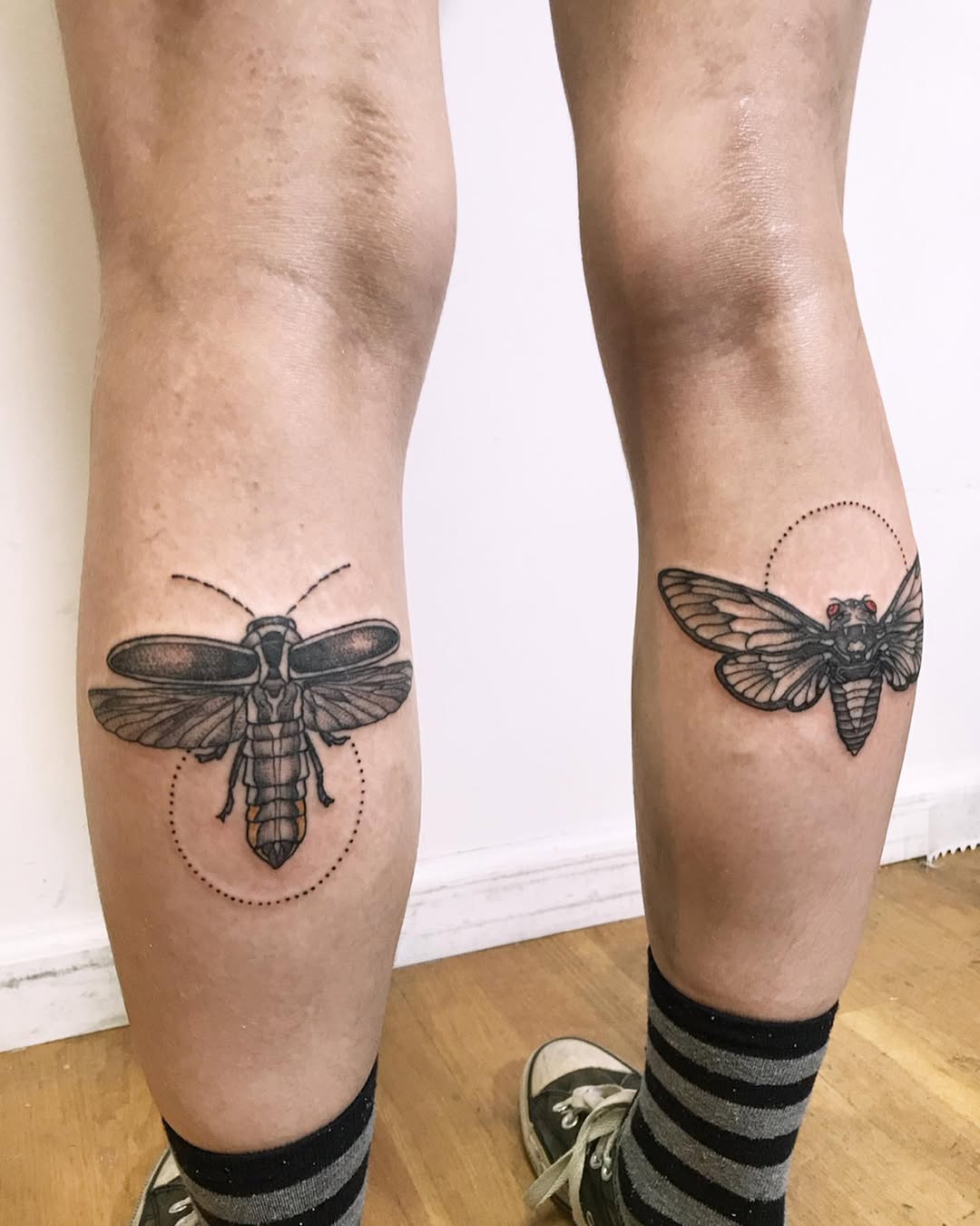 Unique black line art firefly tattoos on knees
