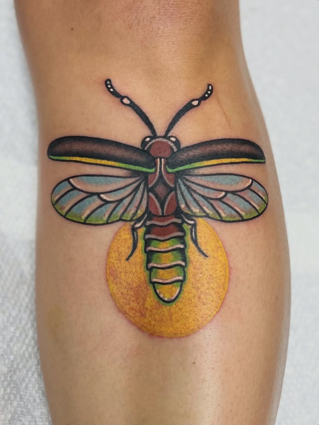 Stunning firefly tattoo with vibrant hues