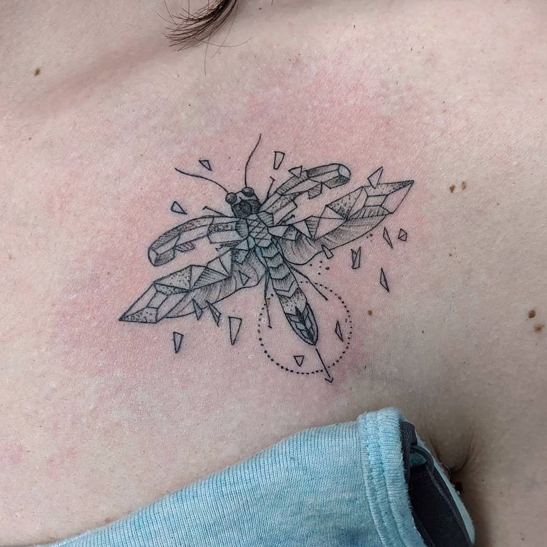 Geometric firefly tattoo on soft skin