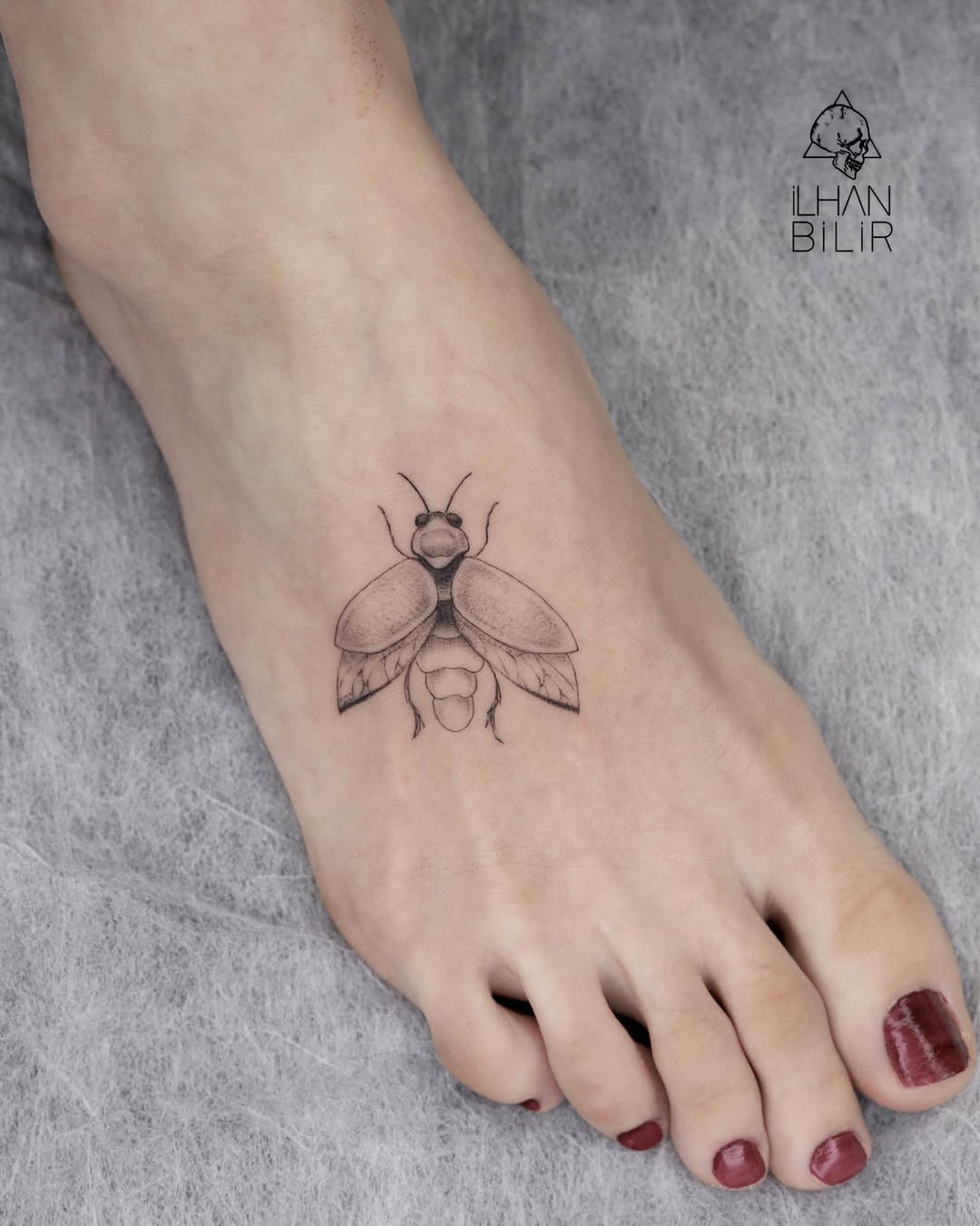 Elegant firefly tattoo on the foot