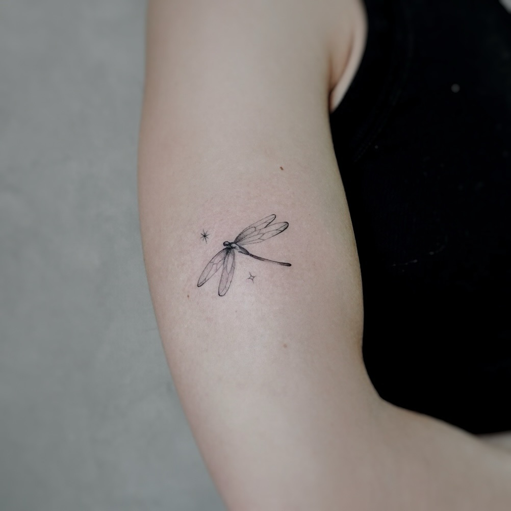 Delicate Firefly Tattoo in Black Ink