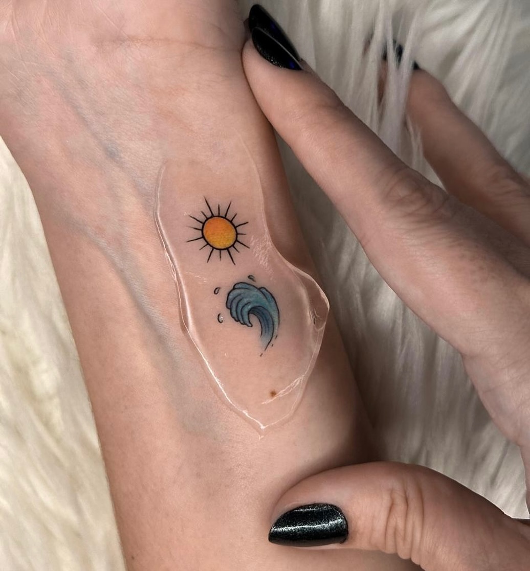 Bright waves and sunshine in a tattoo