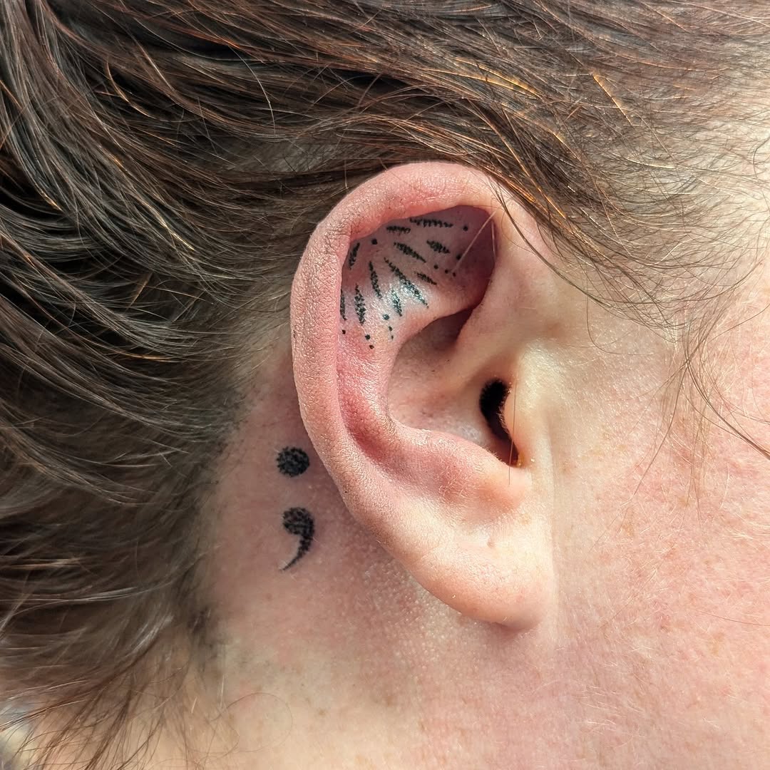 Unique semicolon tattoo behind the ear