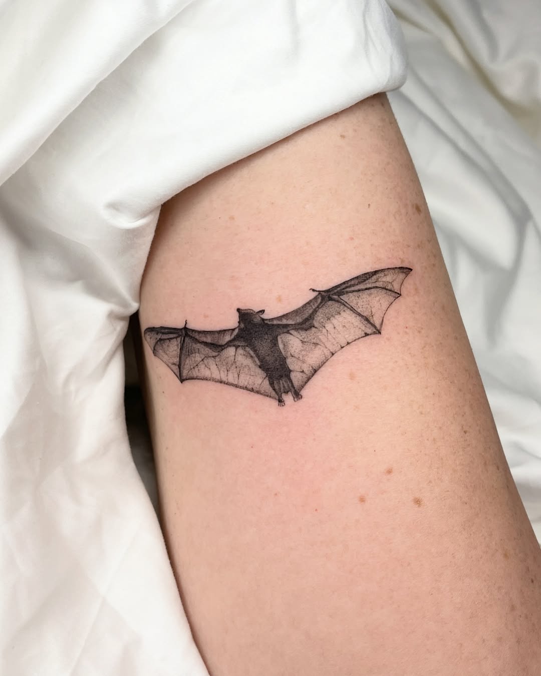 Minimalist bat tattoo with intricate details