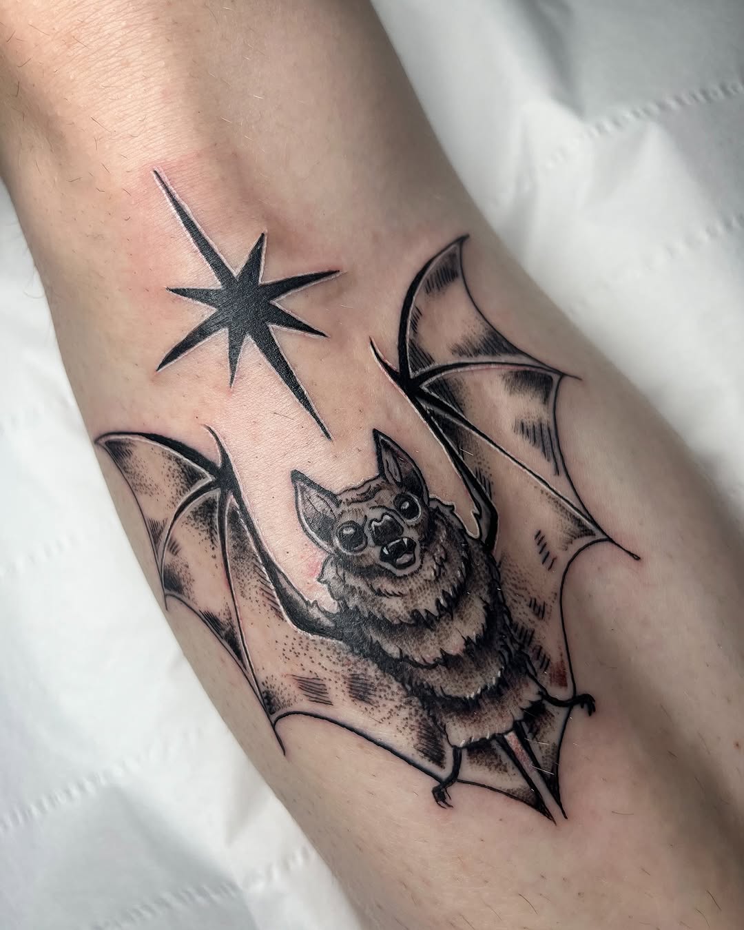 Whimsical bat tattoo with celestial accents
