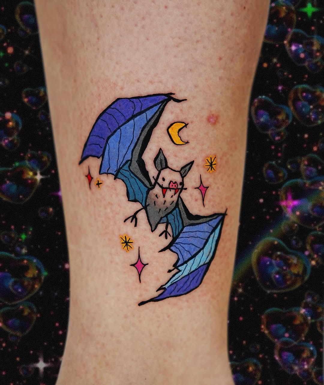 Whimsical bat tattoo with vibrant colors