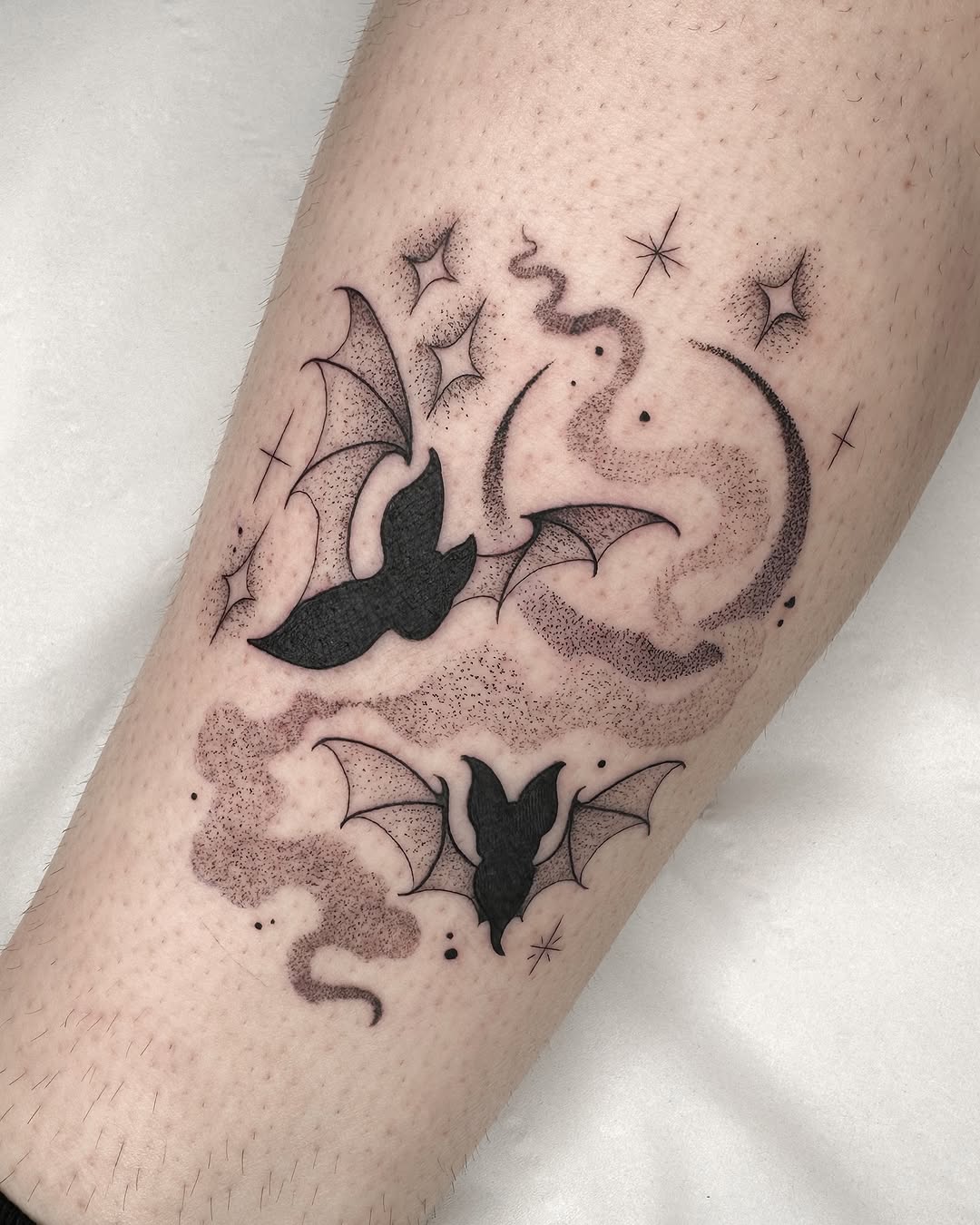 Artistic bat tattoo with celestial elements