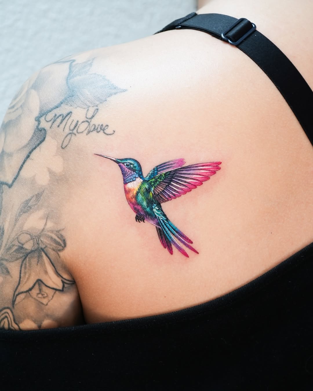 Colorful hummingbird tattoo on shoulder
