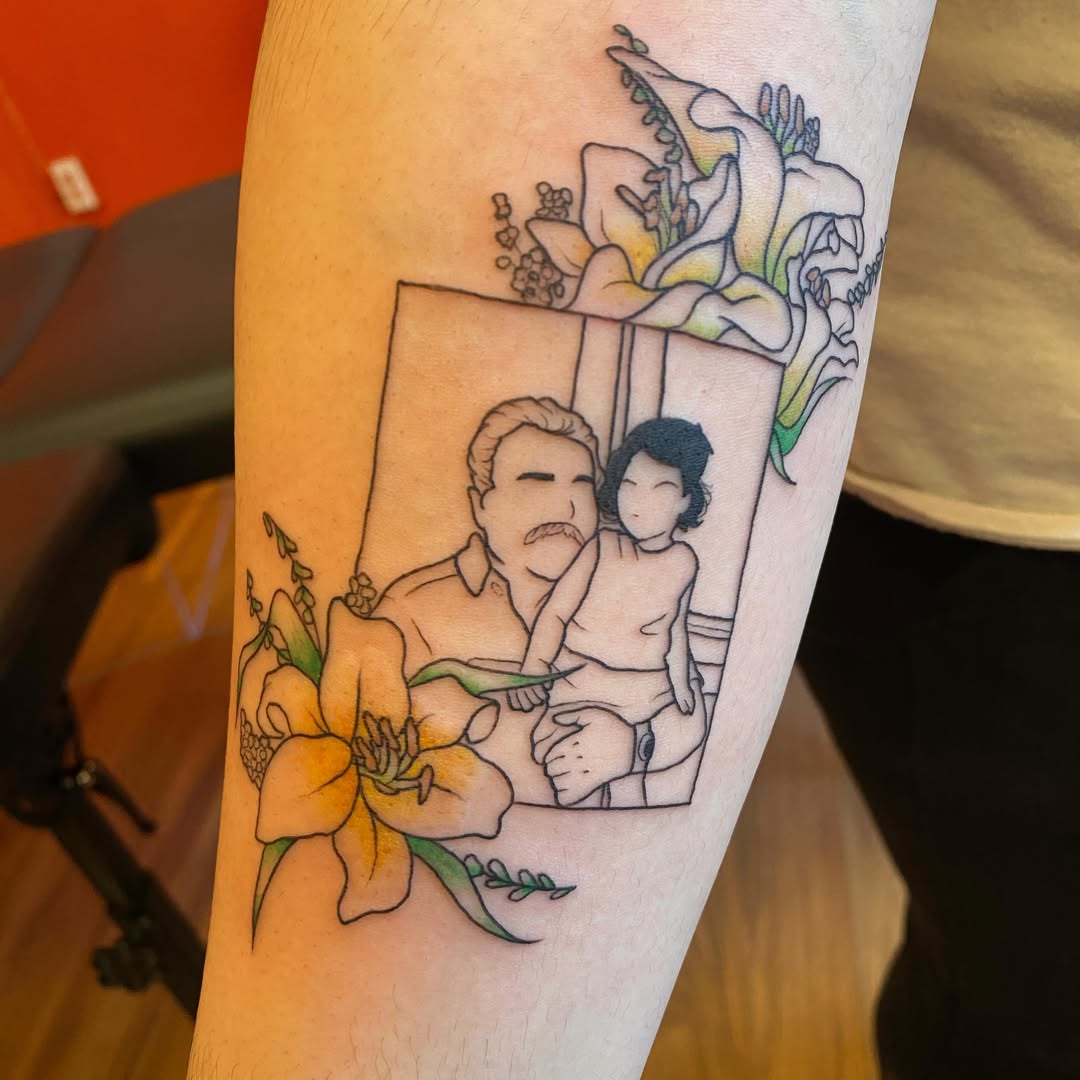 Heartfelt father-daughter portrait tattoo with flowers