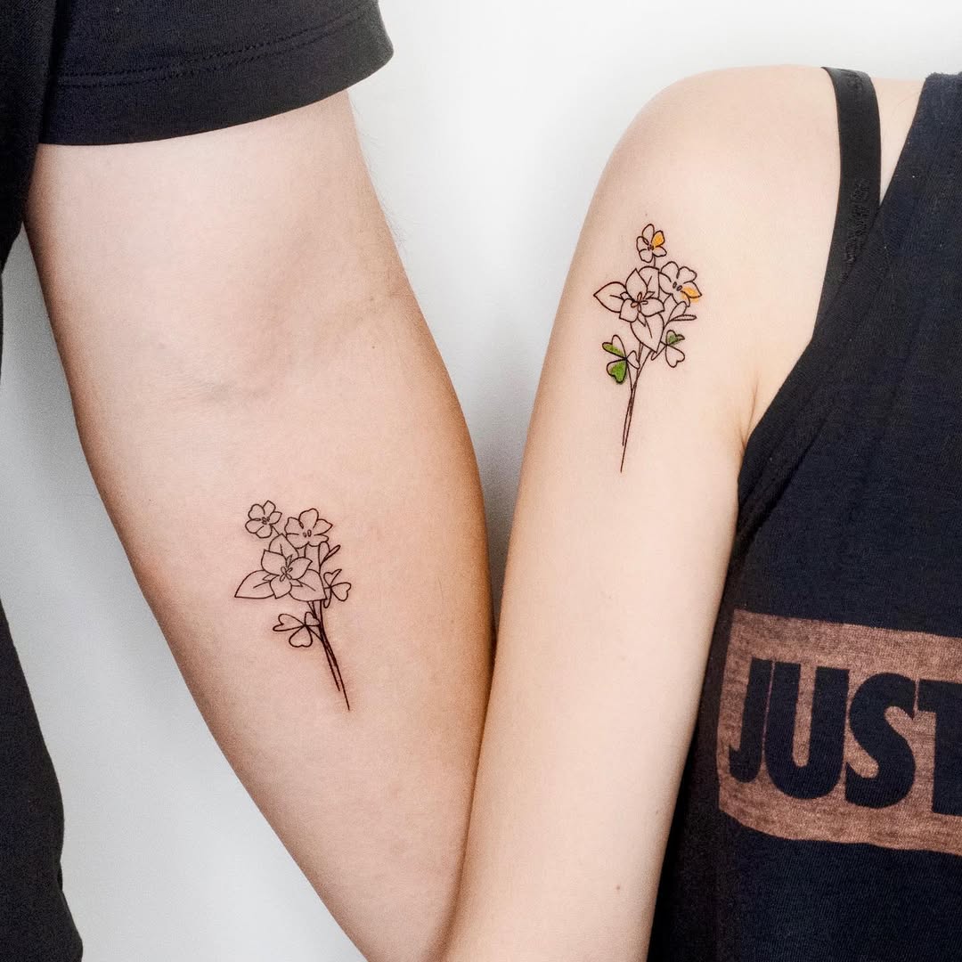 Beautiful complementary flower tattoos for father and daughter