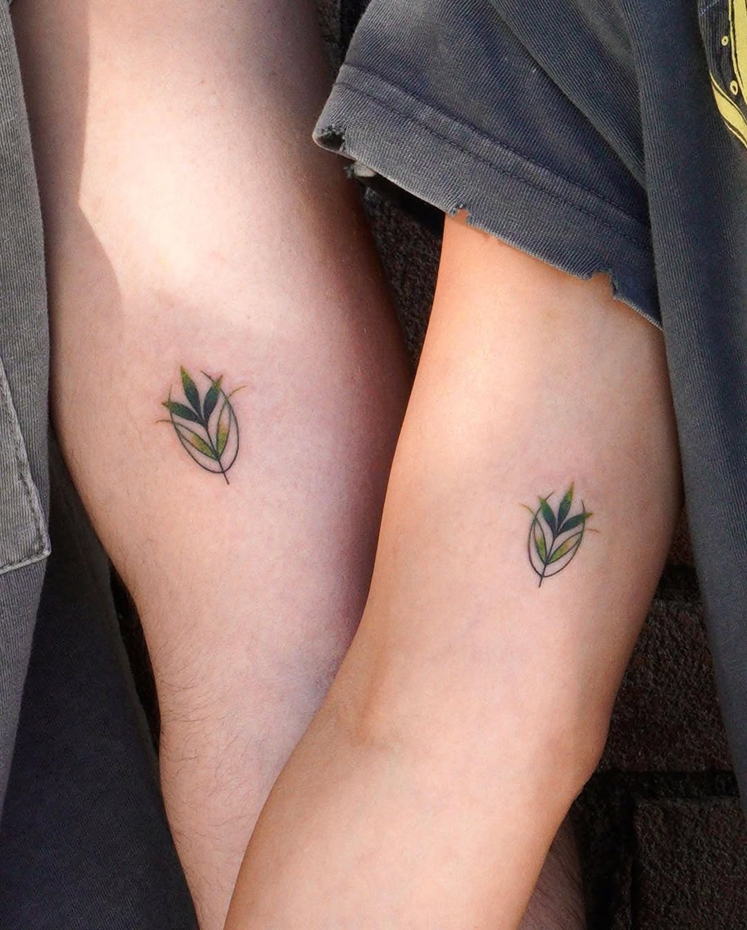 Minimalist leafy tattoos for father and daughter