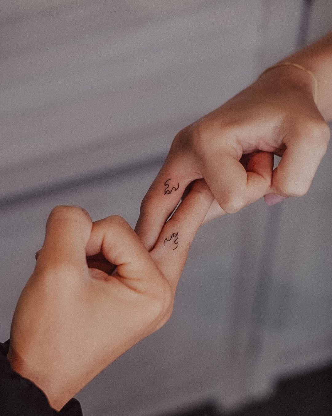 Meaningful father-daughter flame tattoos unite love.