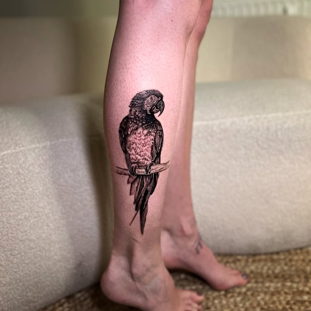 Expressive parrot tattoo design on leg