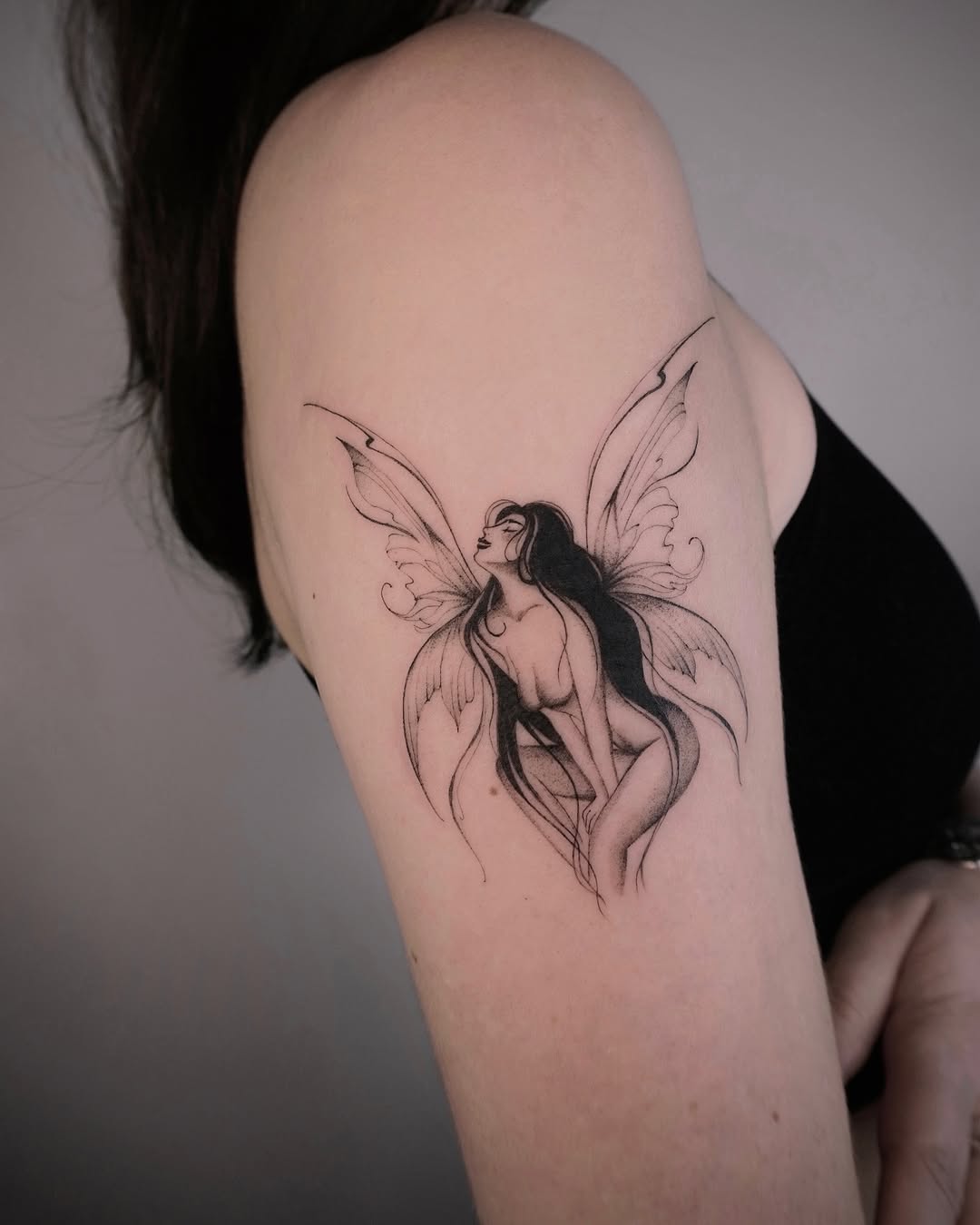 A graceful fairy tattoo with elegant wings