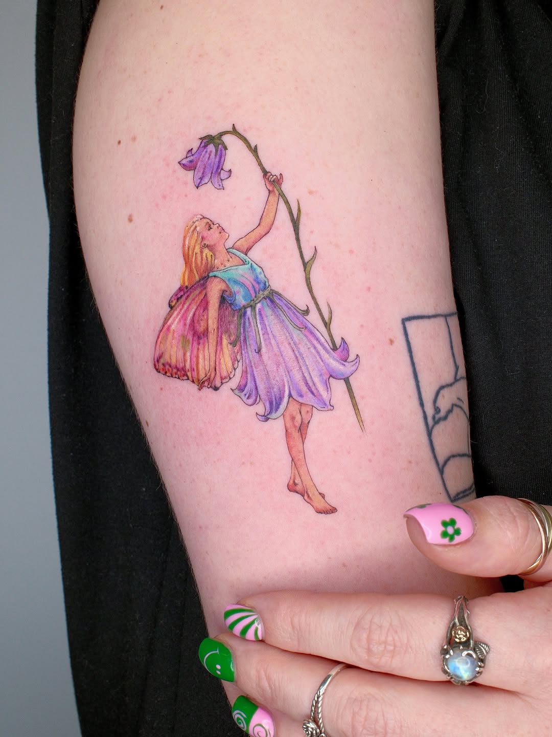 Enchanting fairy tattoo adorned with flowers
