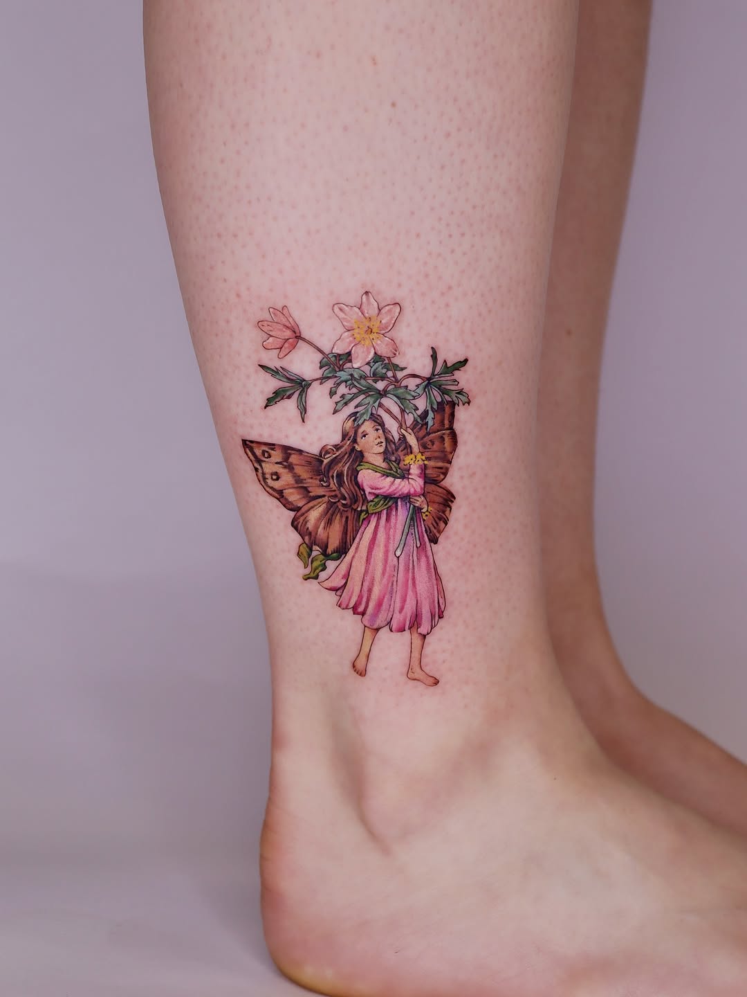 Whimsical fairy tattoo with butterfly and flowers