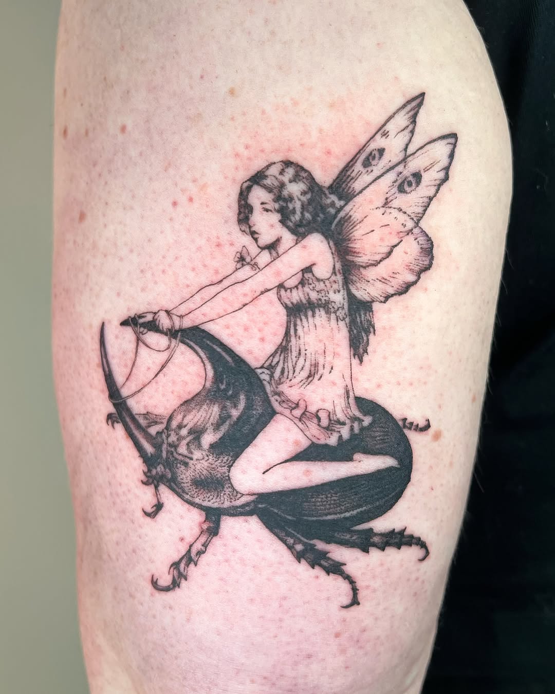 Whimsical fairy riding a beetle tattoo