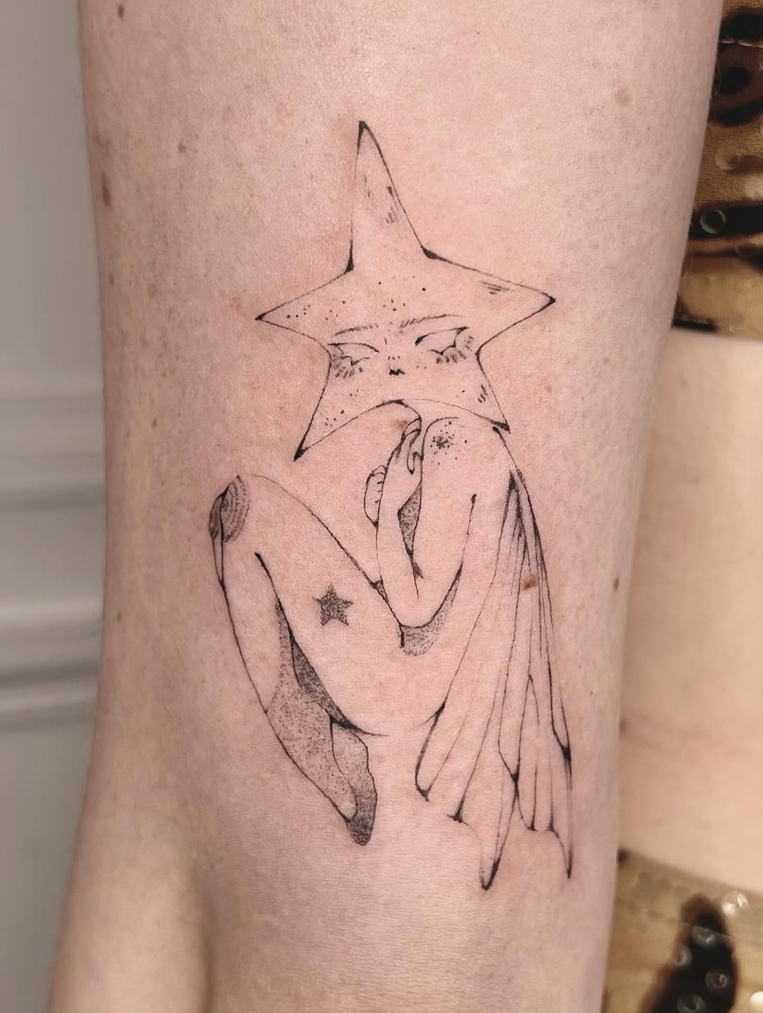 Minimalist fairy tattoo with a star theme