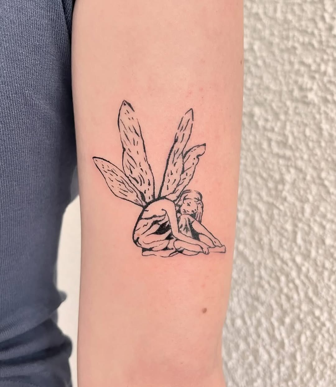 Whimsical fairy tattoo with delicate wings