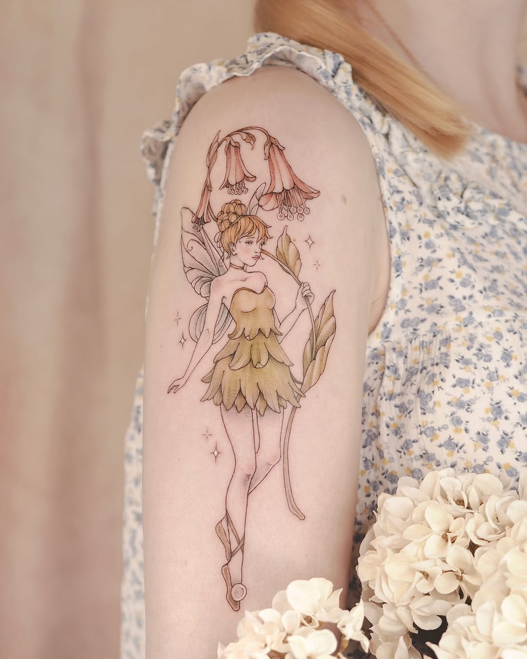 Enchanting fairy tattoo with floral elements