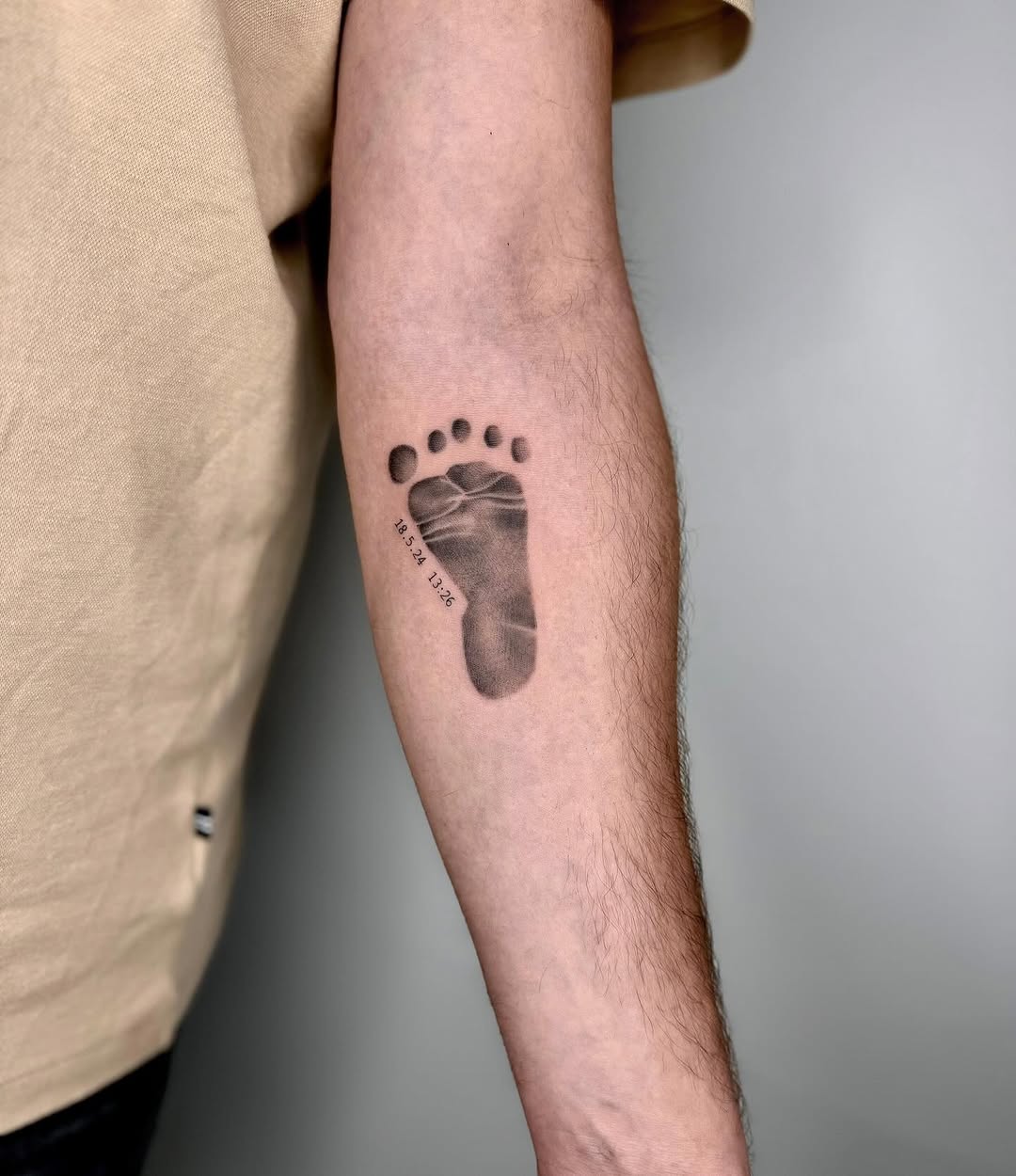 Beautiful family footprint tattoo capturing a moment