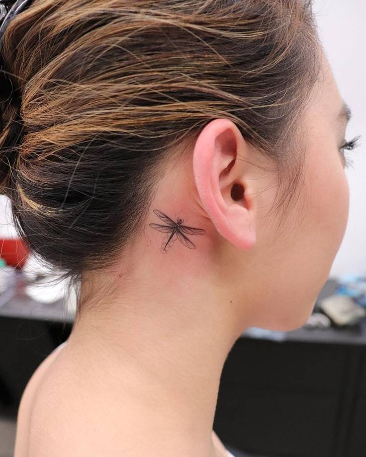 Single needle dragonfly tattoo behind the ear