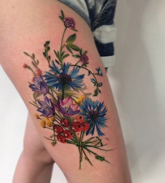 Colorful wildflowers tattoo on the thigh - Tattoogrid.net