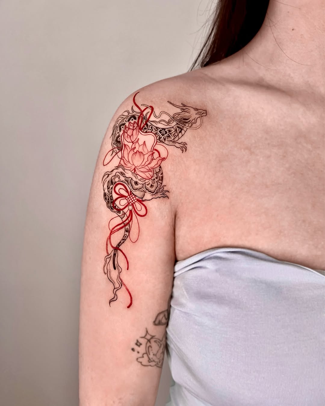 Elegant dragon and lotus arm tattoo design