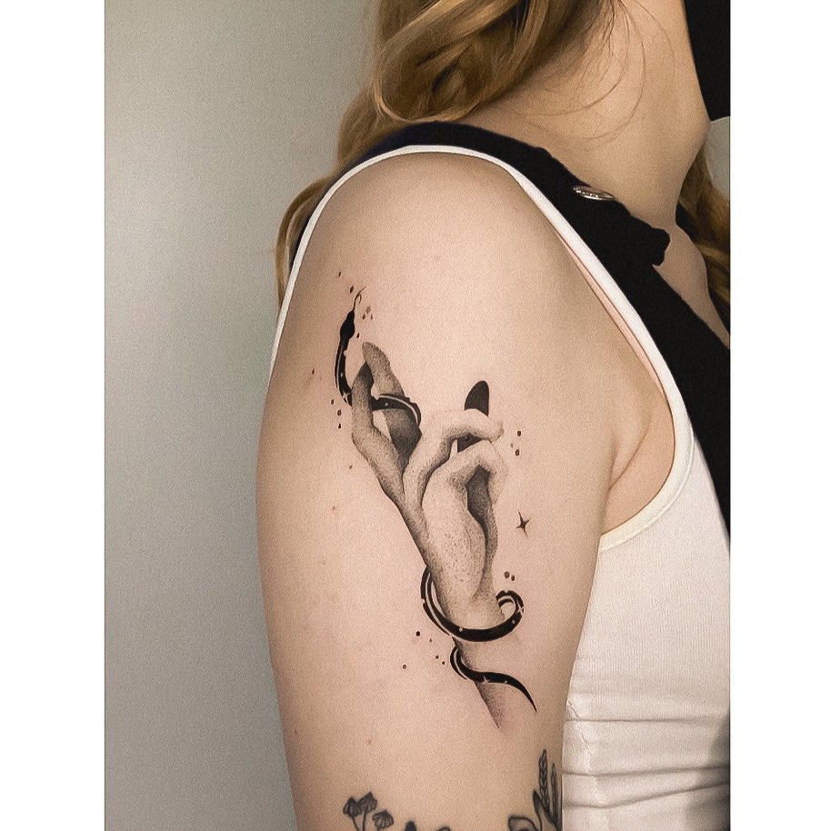 Elegant hand tattoo with flowing ribbon design