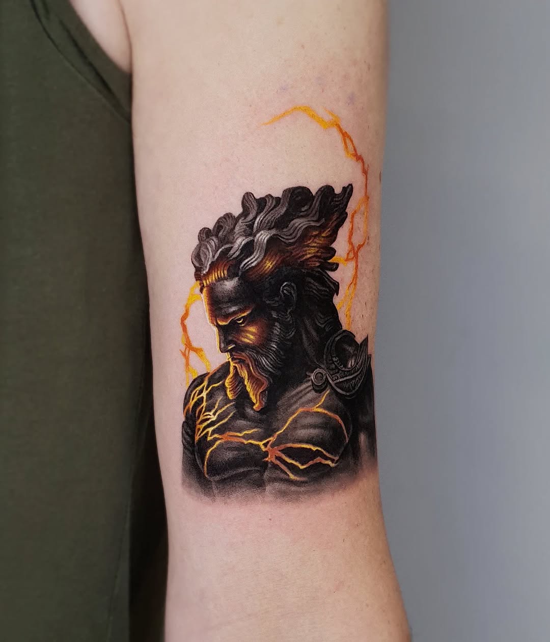 Rugged Zeus Tattoo with Striking Lightning Bolts