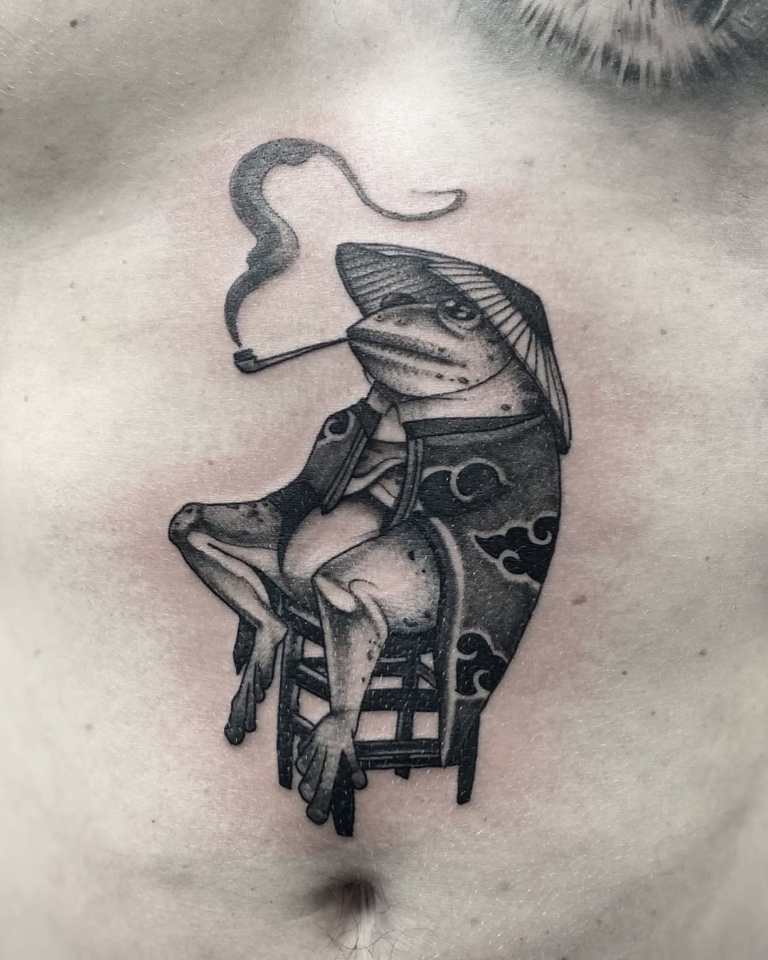 Charming Japanese-style frog tattoo with a twist