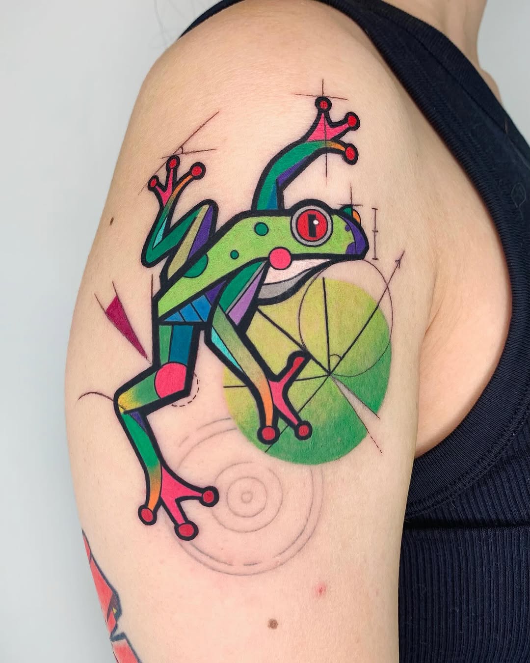 Vibrant geometric frog tattoo captures playful essence