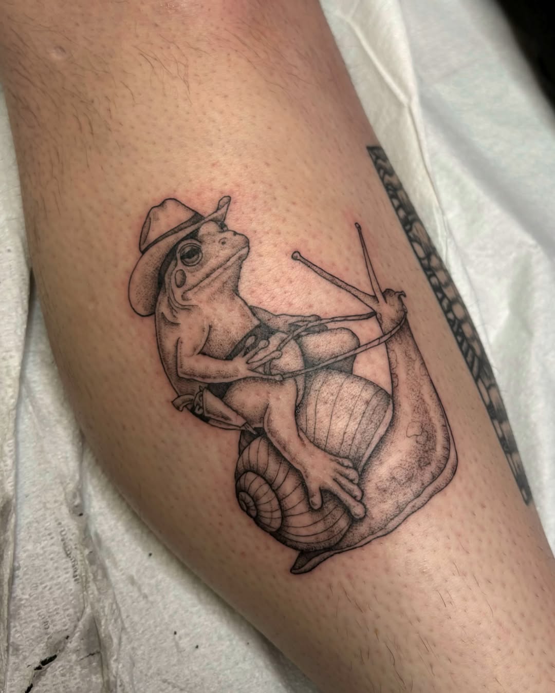 Frog tattoo with a playful cowboy twist
