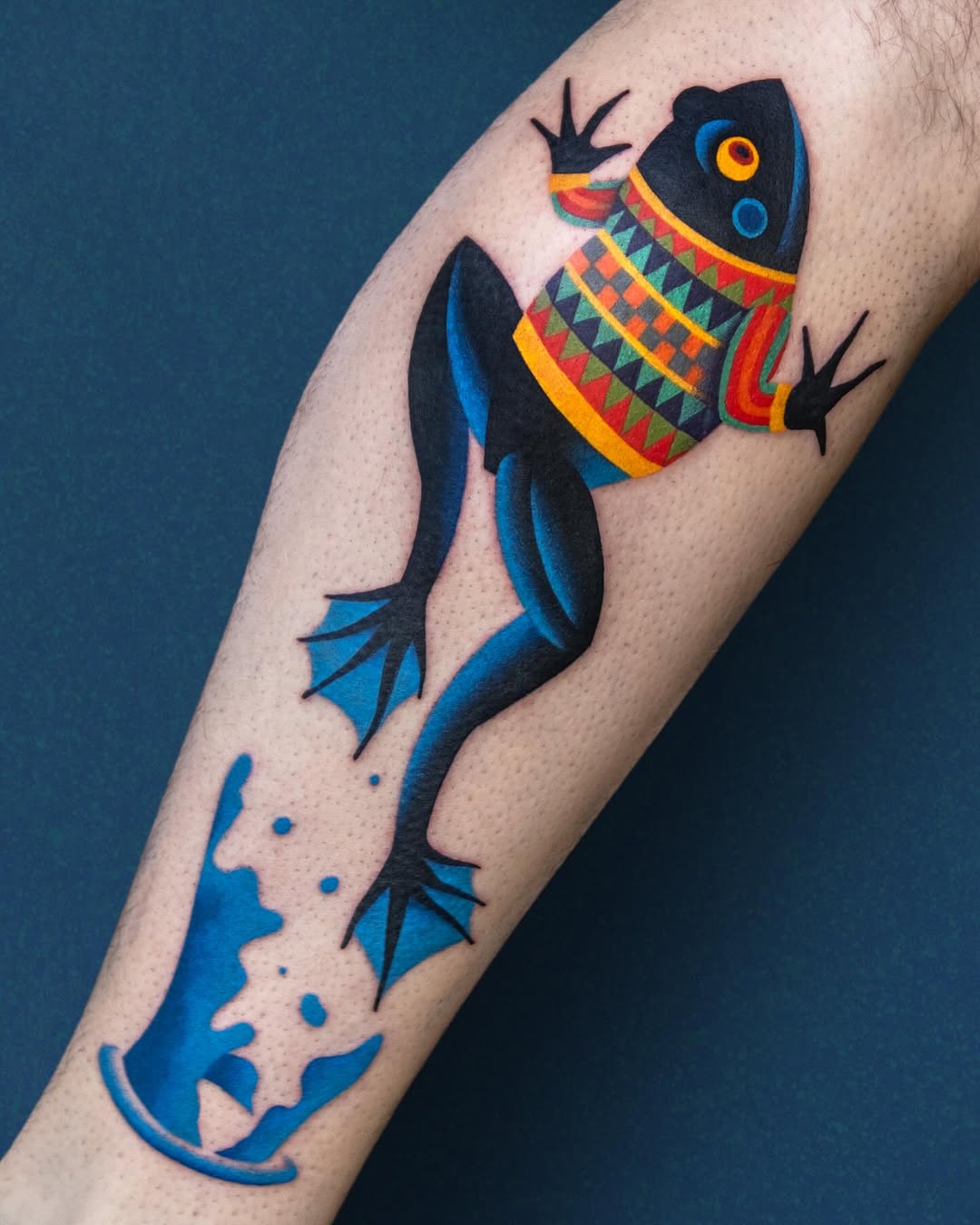 Vibrant frog tattoo with unique sweater design