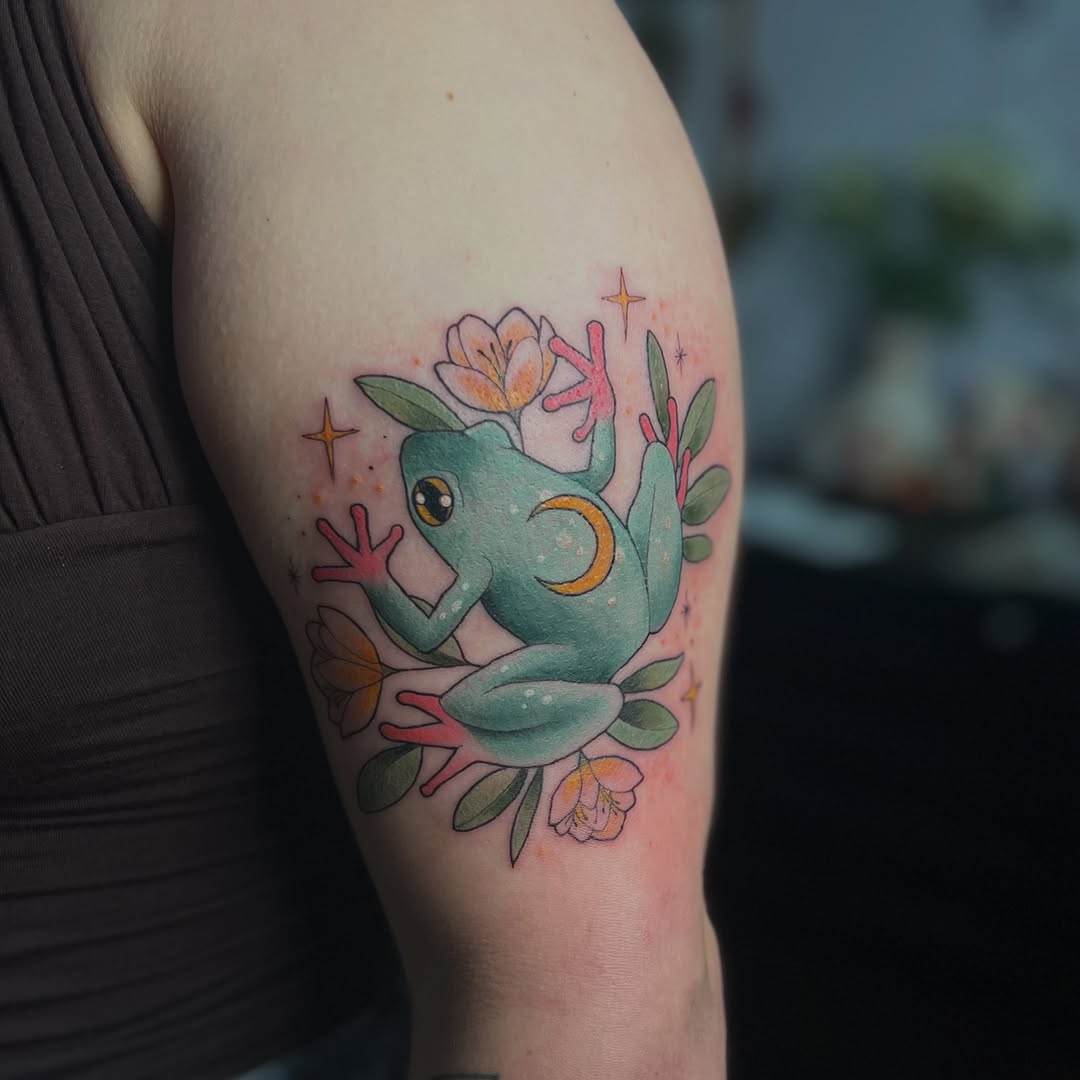 Whimsical frog tattoo with floral accents