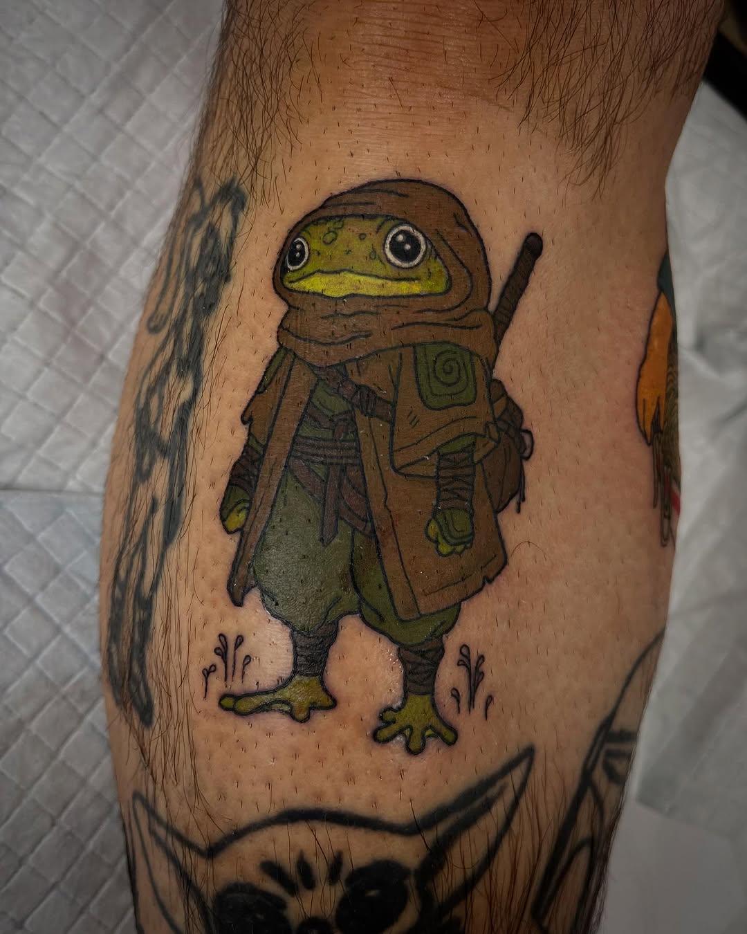 Adventurous frog tattoo with a fantasy twist