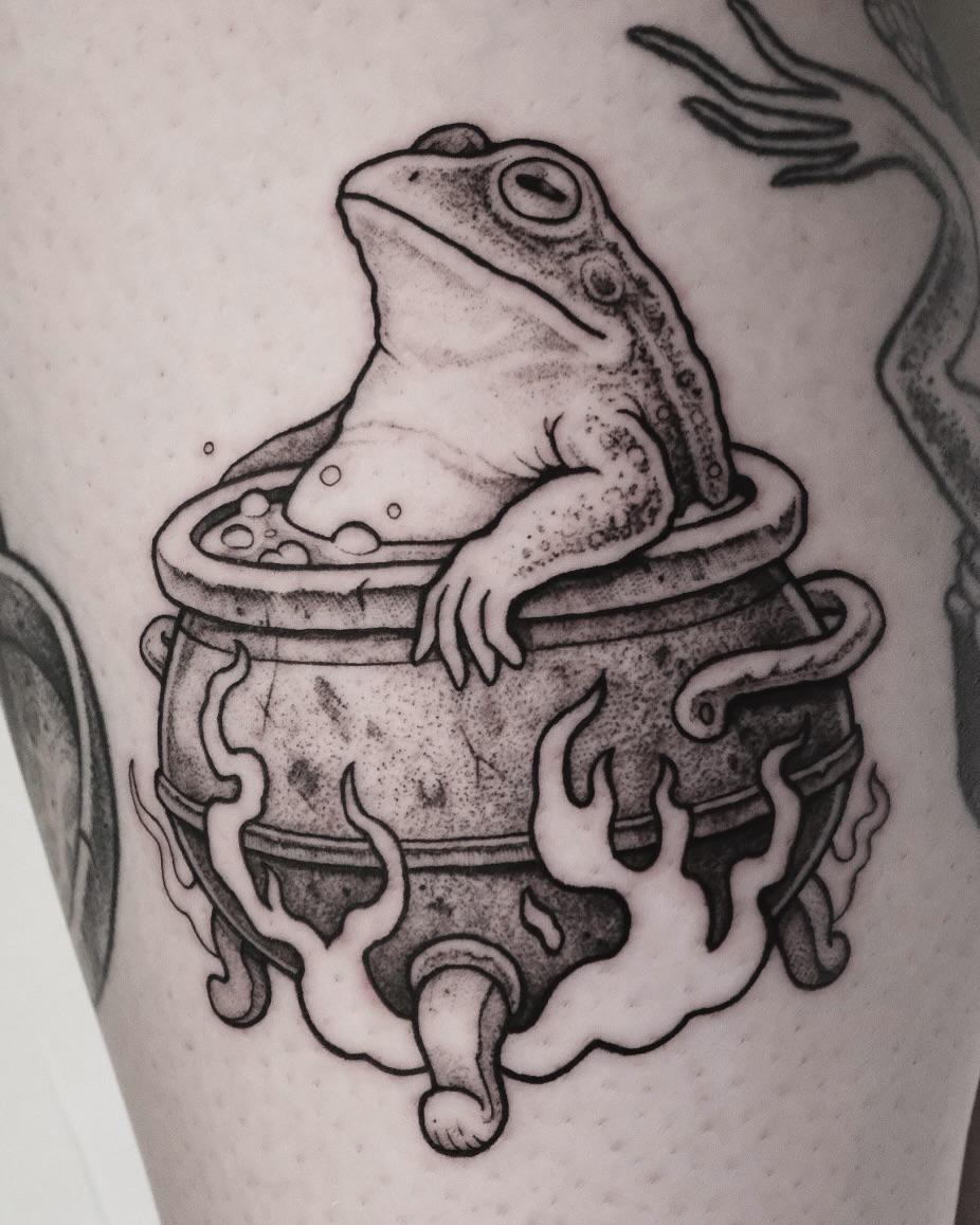 Whimsical frog lounging in a cauldron