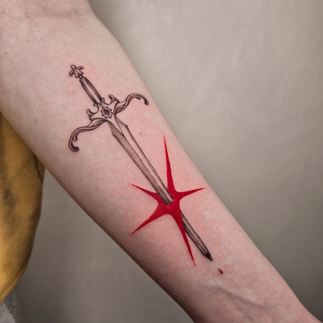 Striking sword tattoo with vibrant red accents