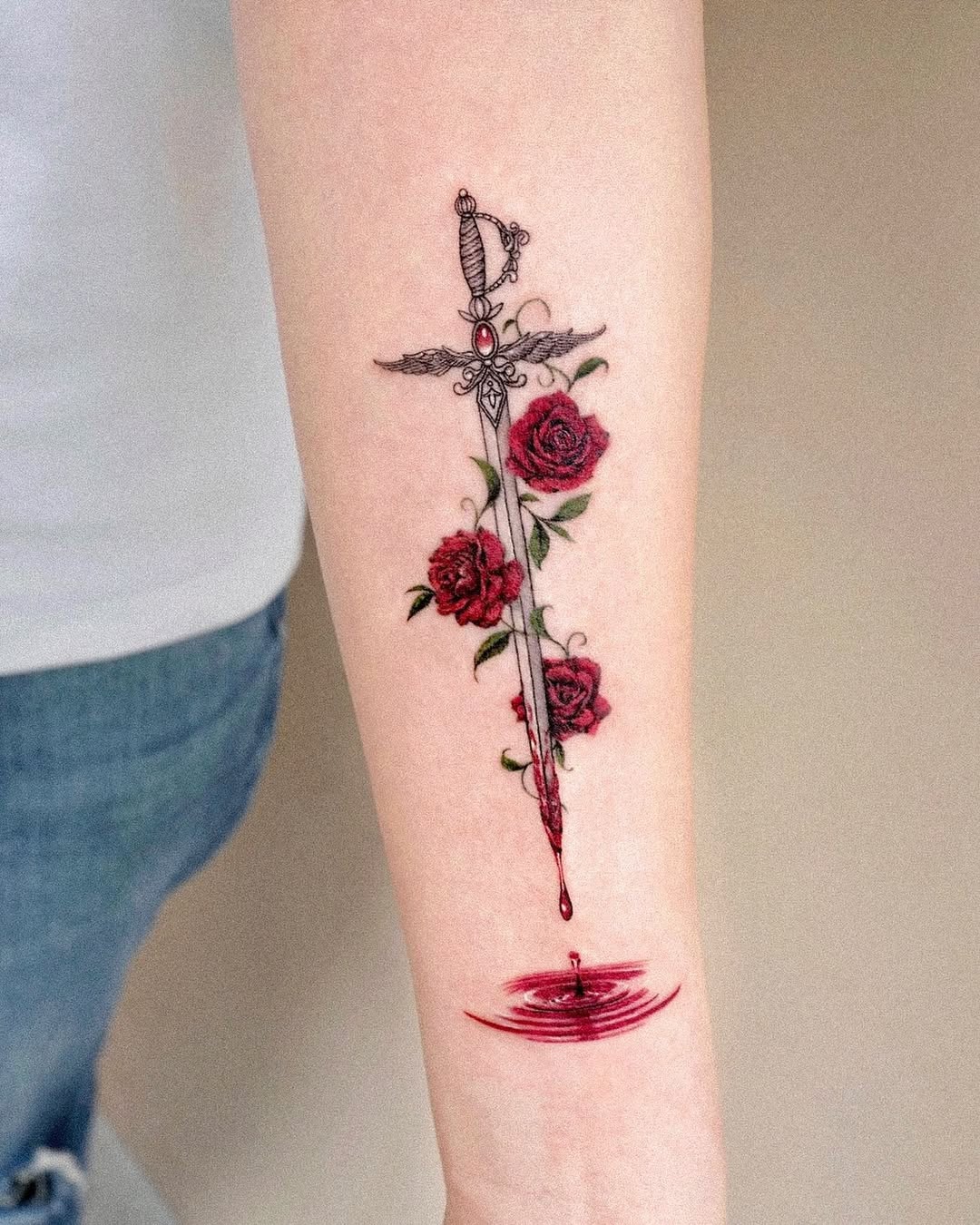 Elegant sword and rose tattoo combination