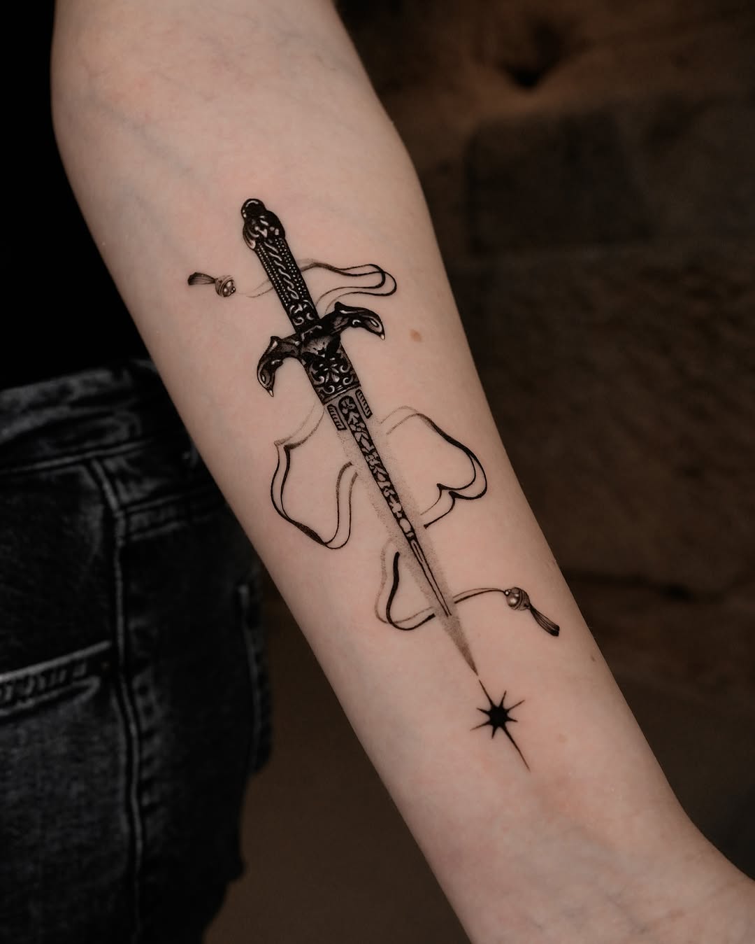Intricate sword tattoo with flowing design elements