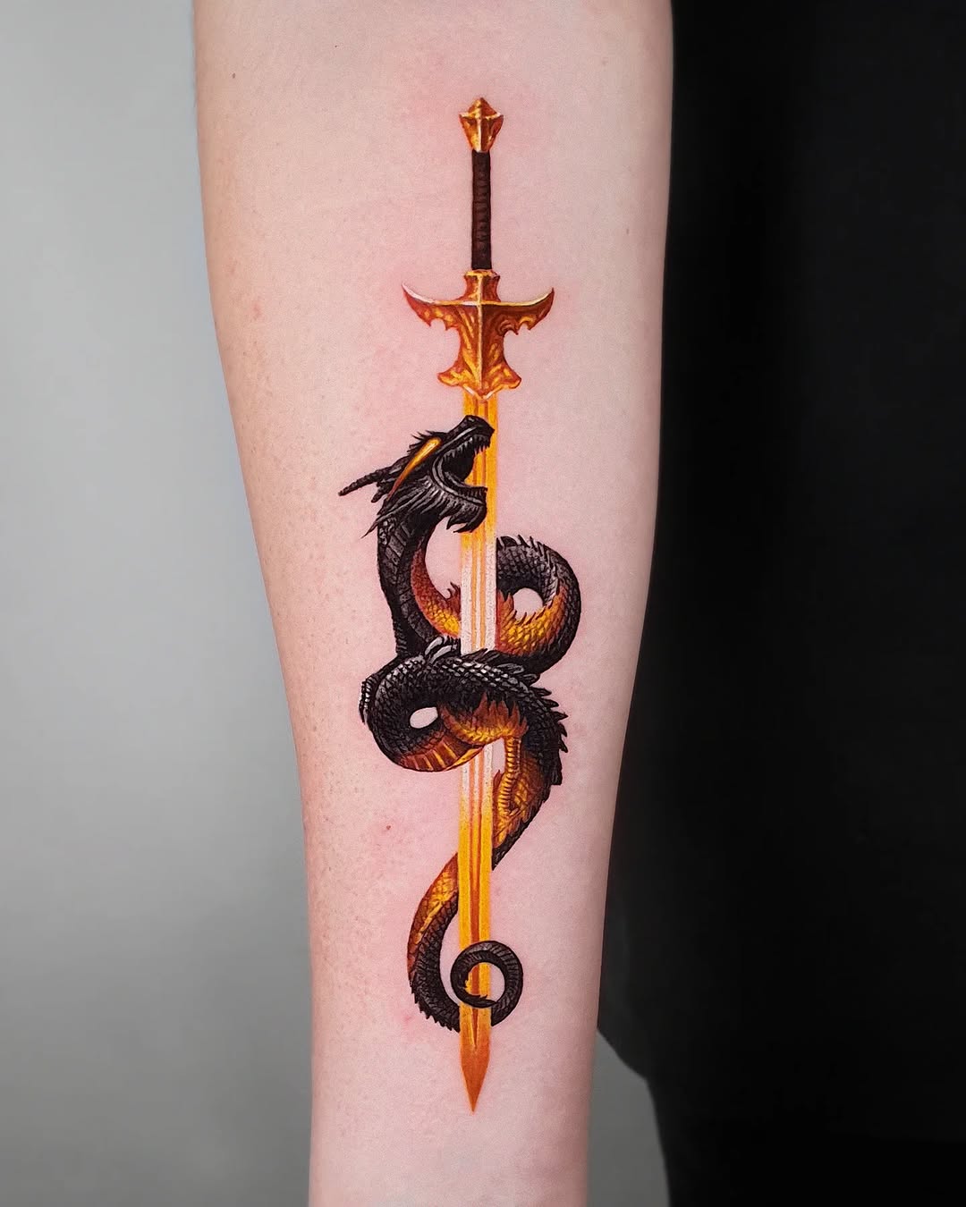 Striking sword and dragon tattoo design