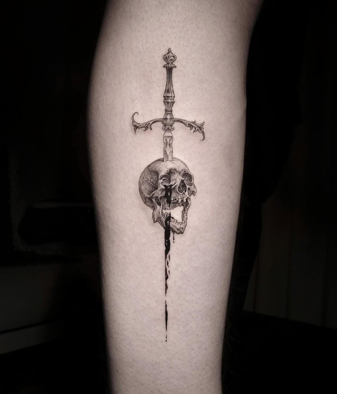 Dark elegance of sword and skull tattoo