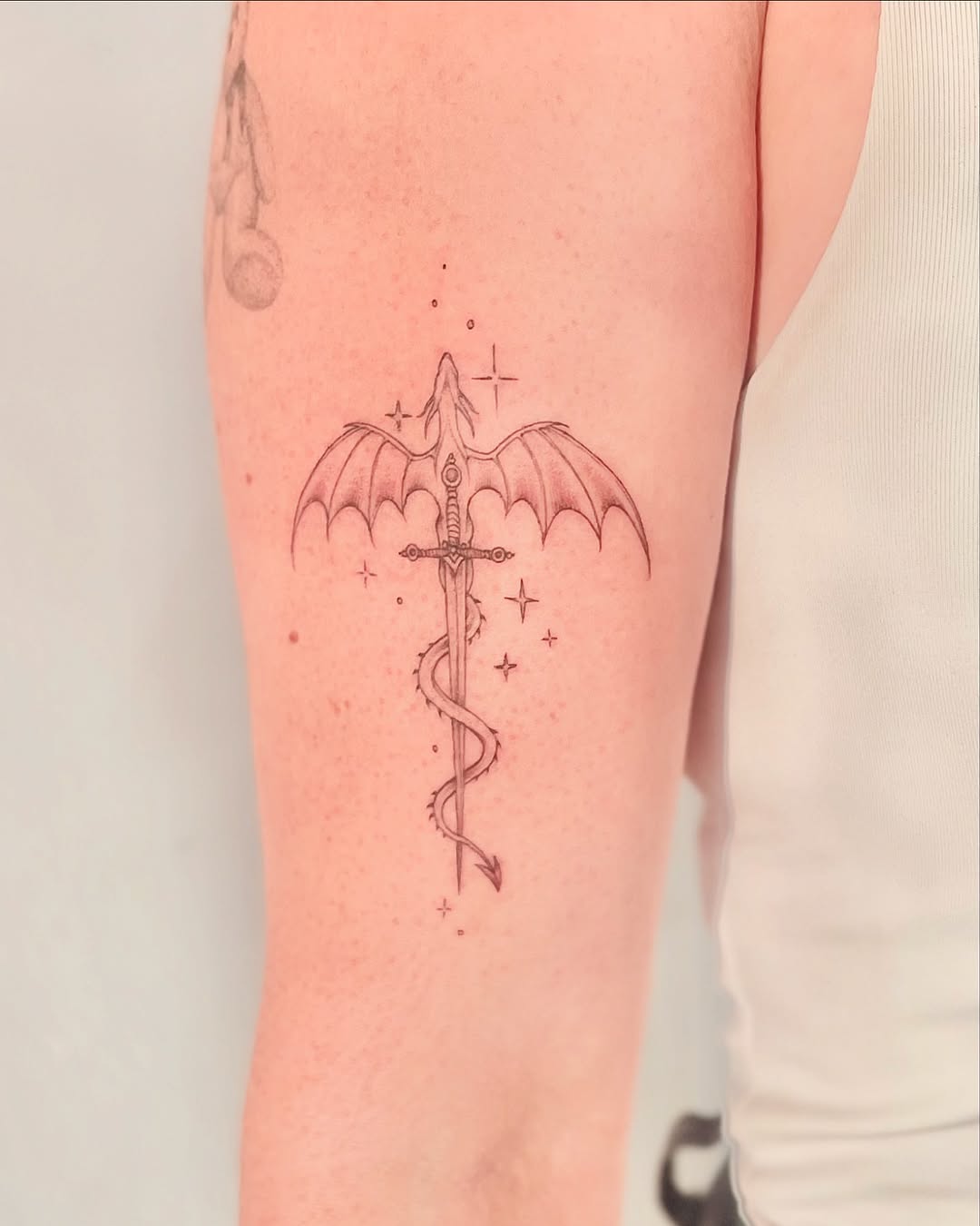 Intricate sword tattoo with bat wings design